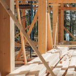 Sunlit construction site with wooden lumber arranged in rows. Perfect for building projects.